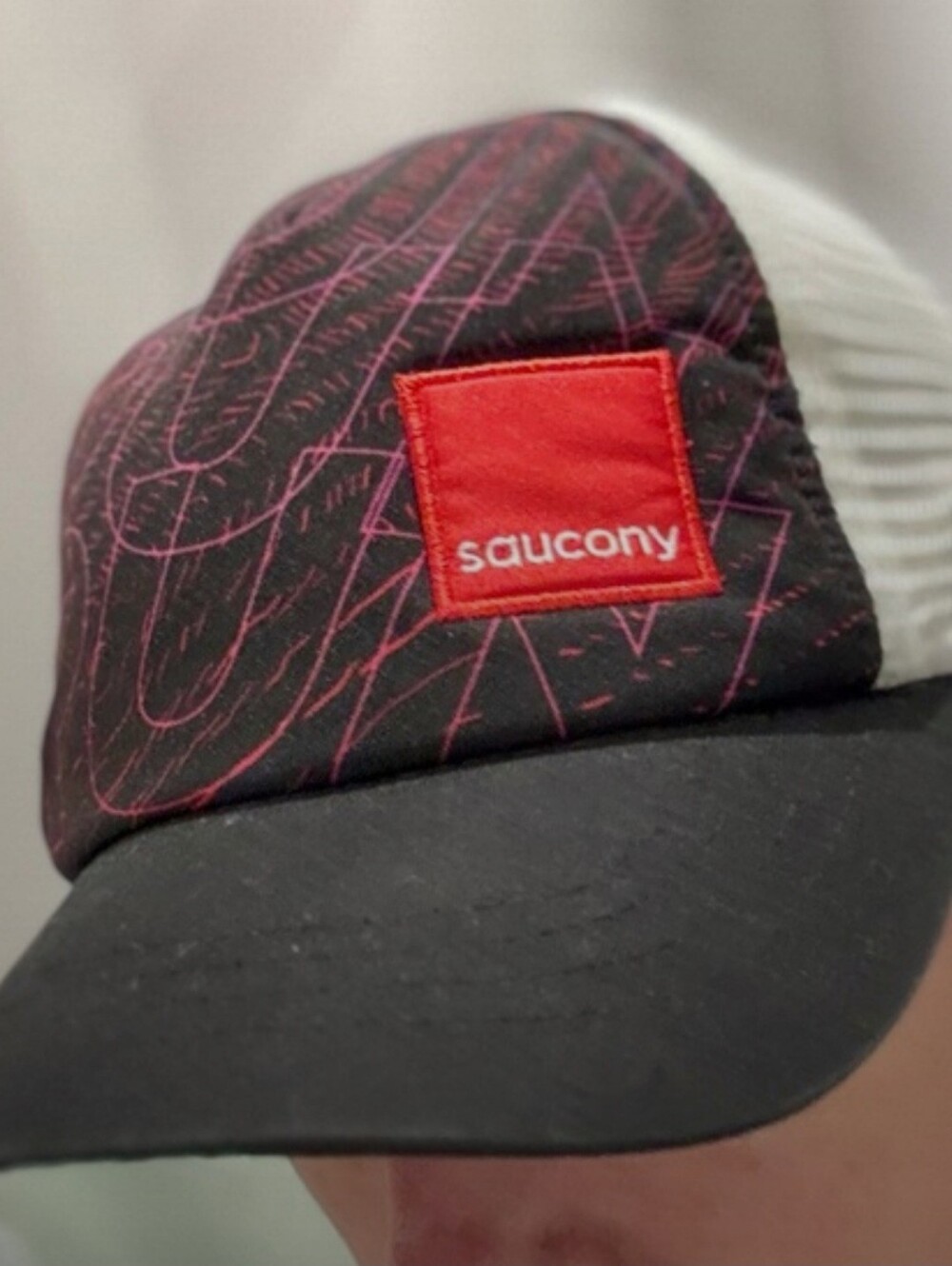 Saucony Black Running Hat with Red Patch and Pink Graphic Lines